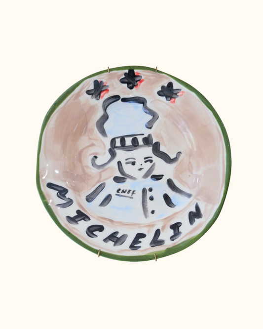 Hand-painted ceramic decorative plate with a michelin star chef