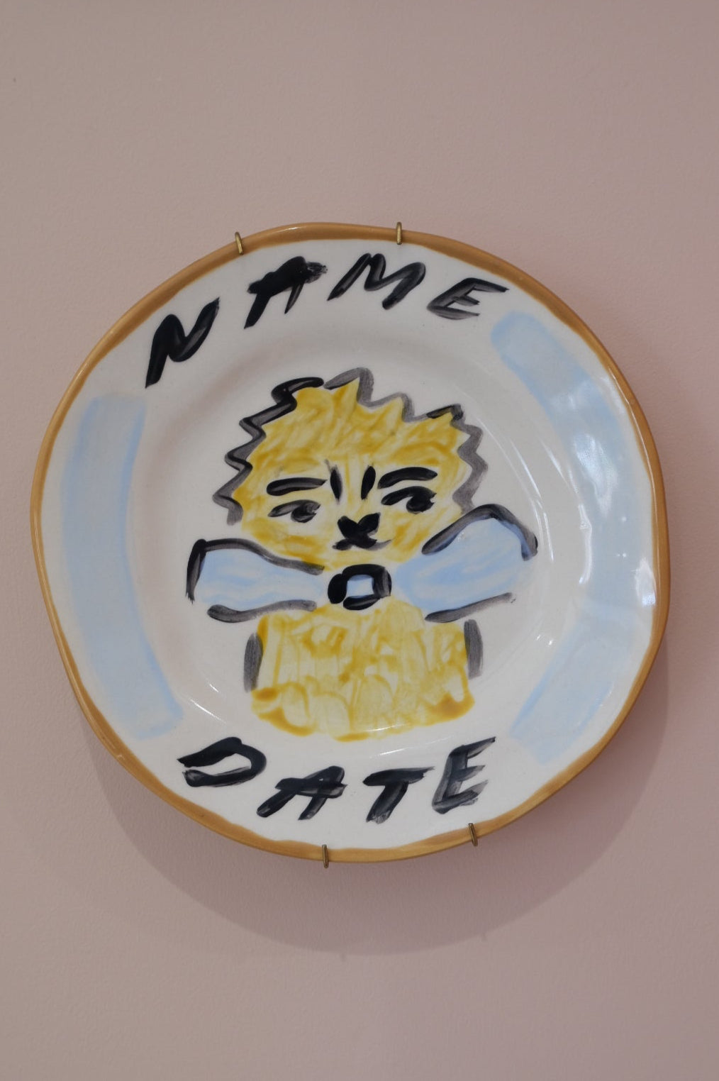 Close up of a personalised plate with hand painted lion design