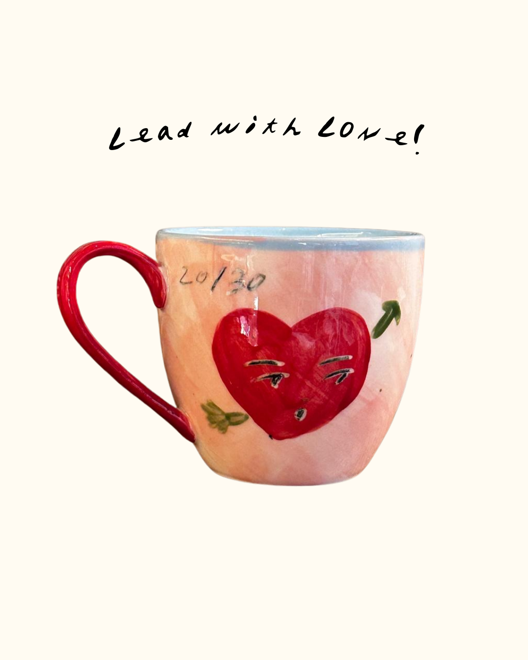 Ceramic mug with a red heart design hand painted by Tatiana Alida for Valentine's gifting