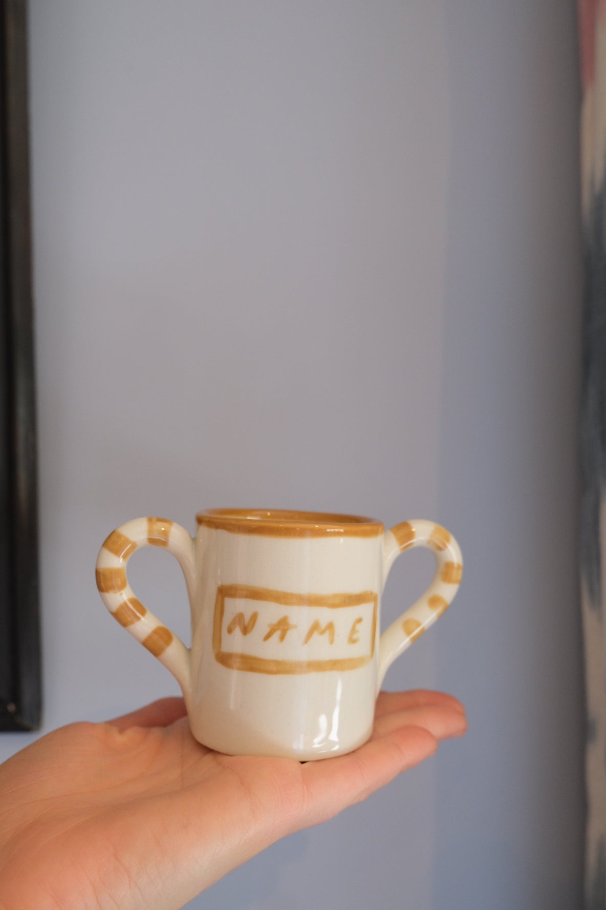 Custom baby mug in white and beige ceramic by Tatiana Alida