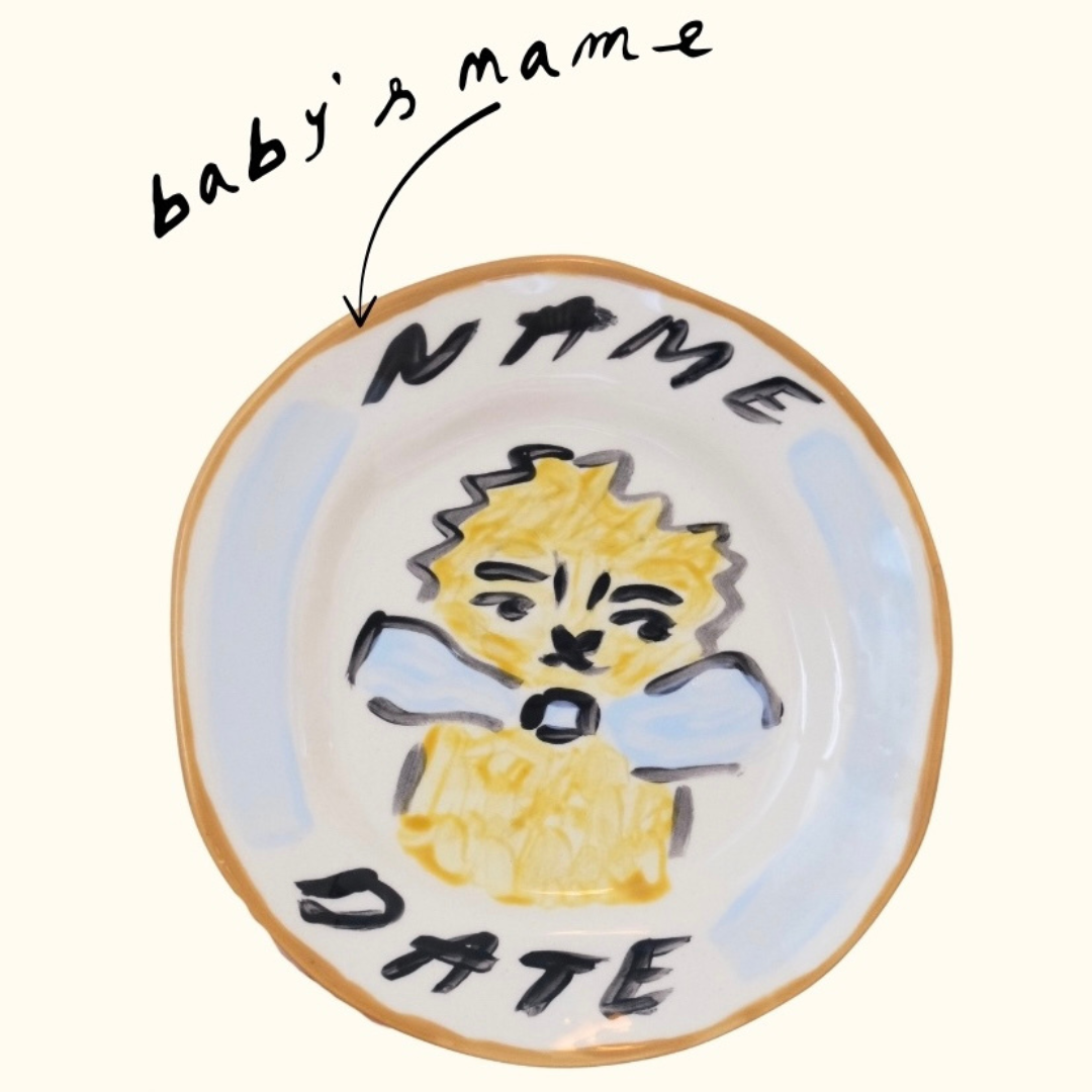Close up of a personalised plate with hand painted lion design, personalised baby gift