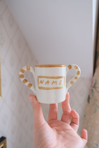 Personalised baby mug in white and beige ceramic by Tatiana Alida Design