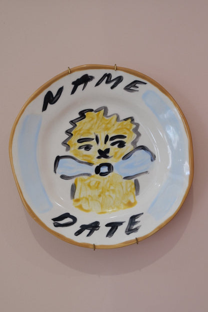 Close up of a personalised plate with hand painted lion design